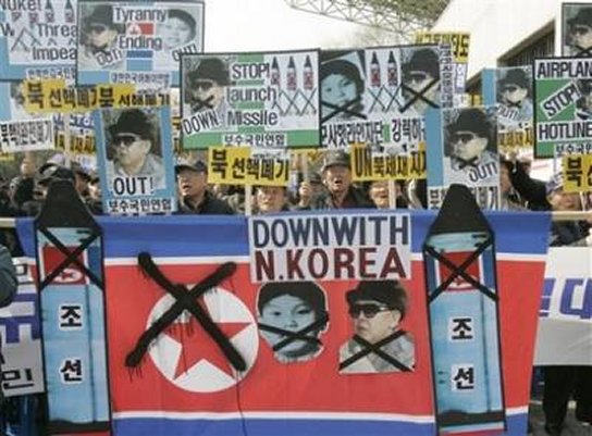 south and north korean flags. South Korean protesters with a