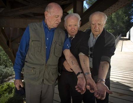  together in Auschwitz, having serial numbers tattooed on their arms.