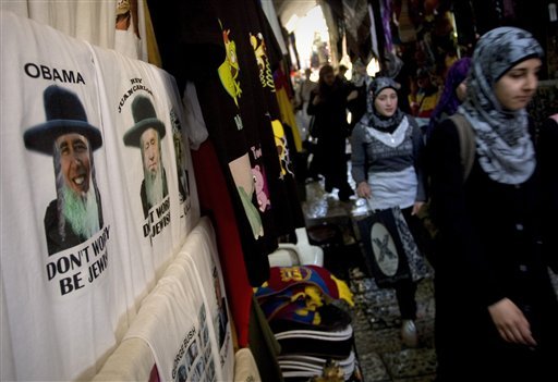  Ultra Orthodox Jewish man, left, is seen in a store as Palestinian women 